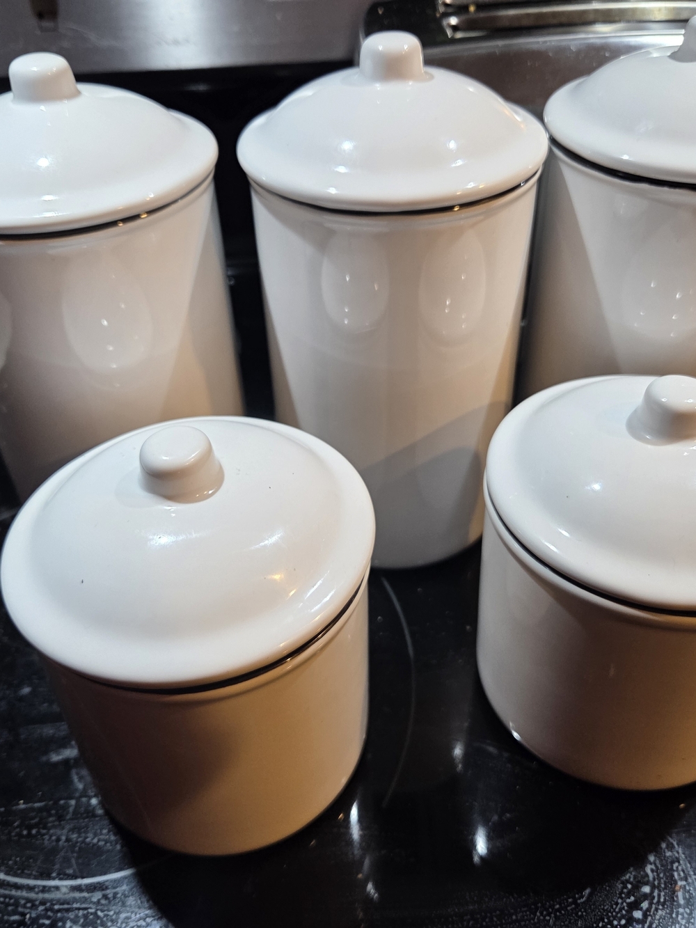 Stokes brand white ceramic canisters featuring a simple design